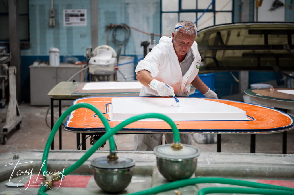 Sealing the resign in at a fibre glass factory.