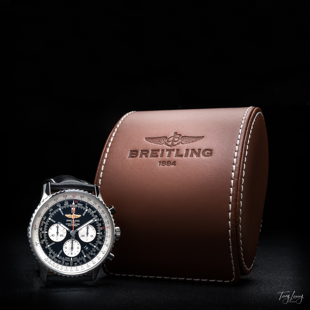 Breitling Navigator watch with brown case photographed on a black background.