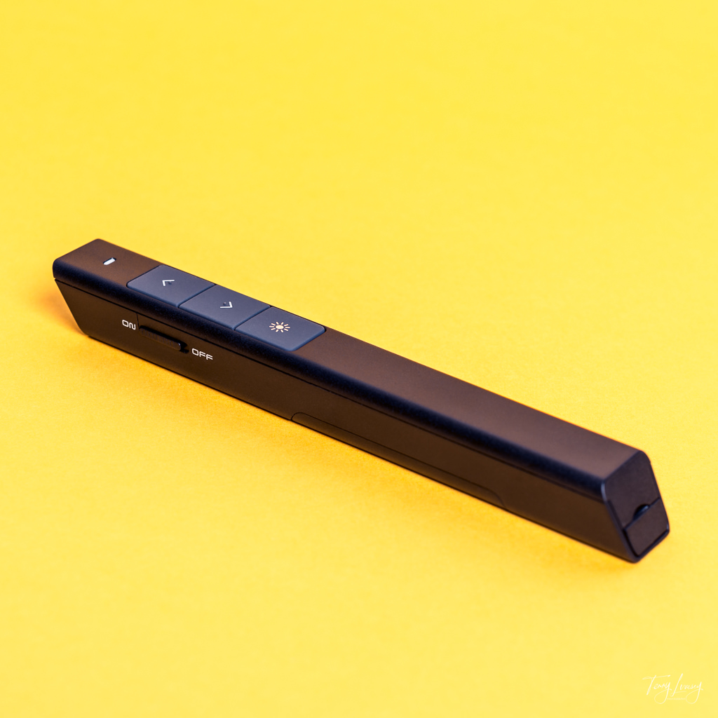 A remote control pointer on a clean yellow background
