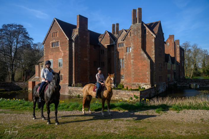 Two women on horses outside Harvington Hall
