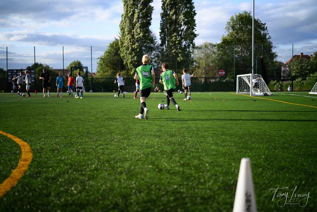Photographs of football students on the pitch of Matt Tally Player Development.