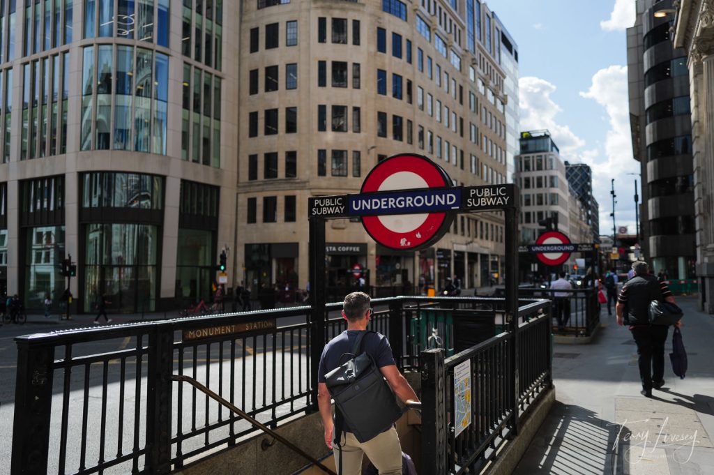 Male model with a PW3R backpack going down the stairs to an underground tube station in London