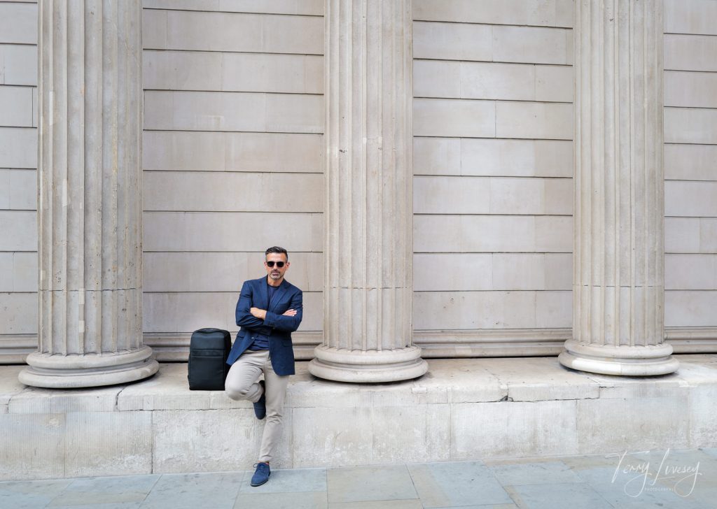 Male model standing next to PW3R backpack