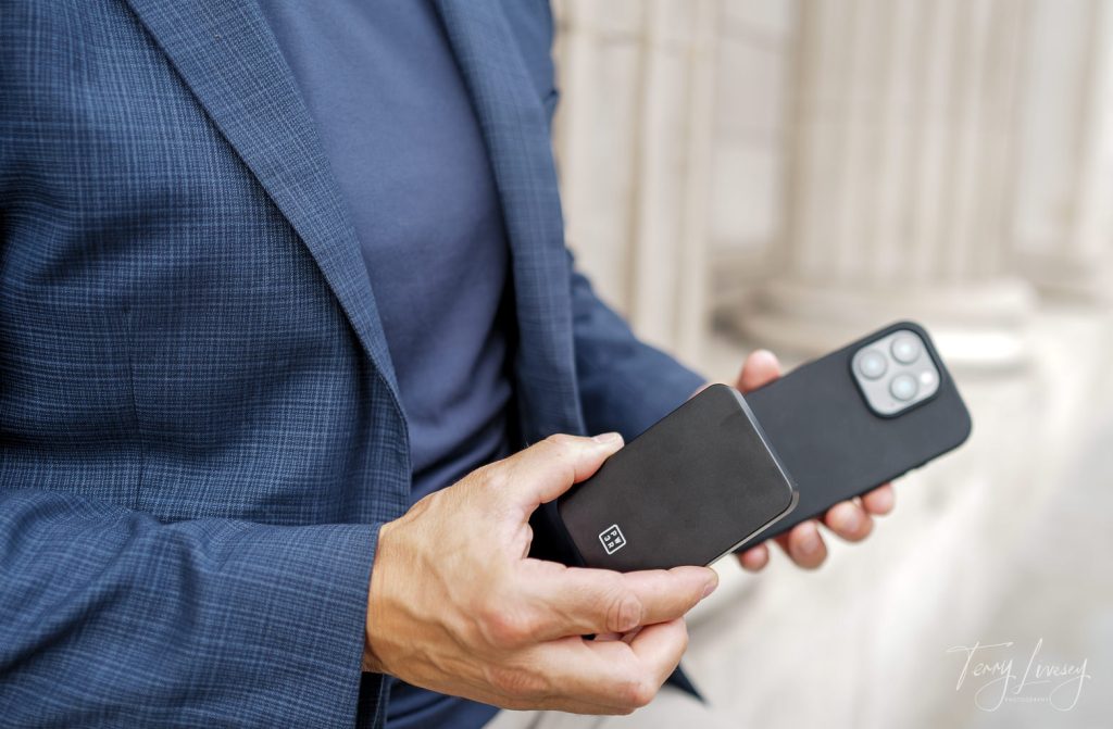 holding a PW3R power bank towards a mobile phone