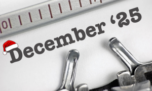 December 25 written on a typewriter with a santa hat on the d