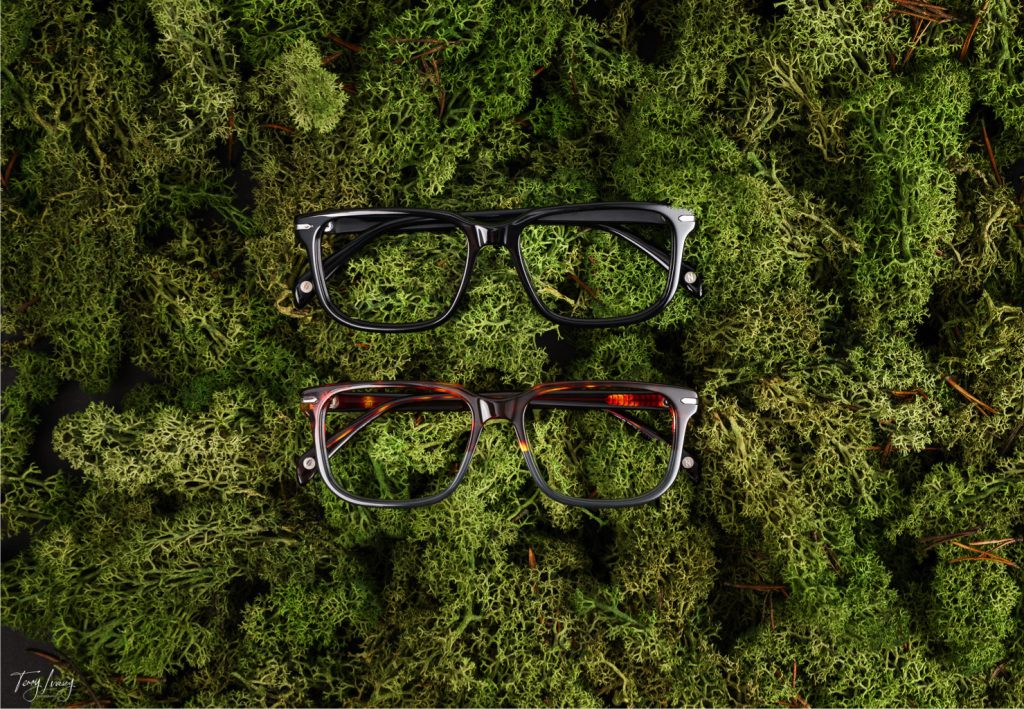 2 pairs of glasses on moss