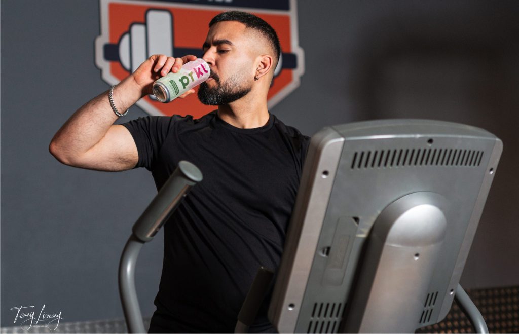 Gym shot of 1 man drinking PRKL