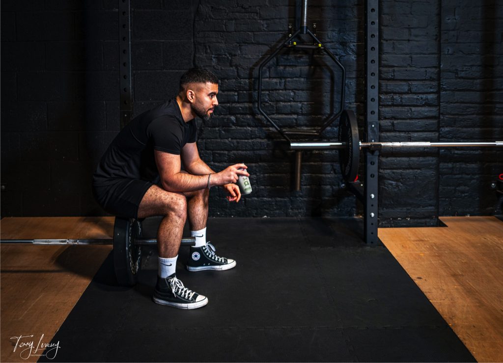 Gym shot of 1 man drinking PRKL