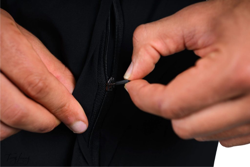Hybrid Hub 365 Shorts with fingers showing the zip