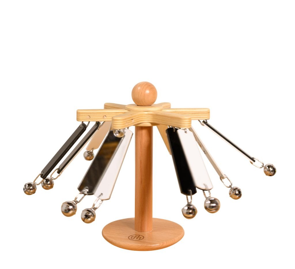 A wooden stand with eight metal chimes hanging from angled arms, each chime ending with a small metal ball, forming a star-like shape. The stand has a round base and a central vertical support.