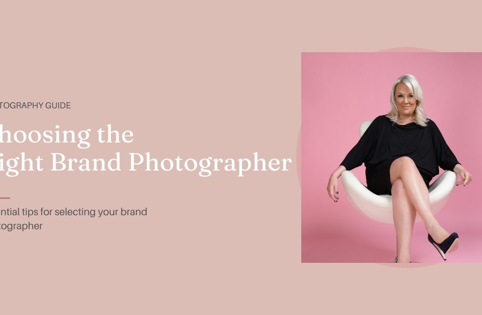 A woman with blonde hair in a black dress sits on a white modern chair against a pink background. Text reads: Choosing the Right Brand Photographer: Essential tips for selecting your brand photographer.